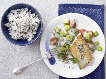 Fried hake with rice, onions and tomatoes