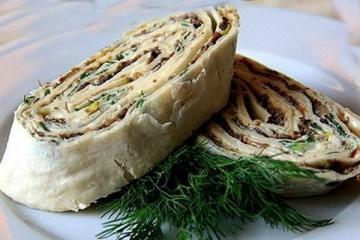Roll from lavash with mushrooms, cheese and herbs. Snack on New Year's Eve