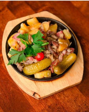 Russian "Zharenko" with potatoes, meat and sausage. Delicious