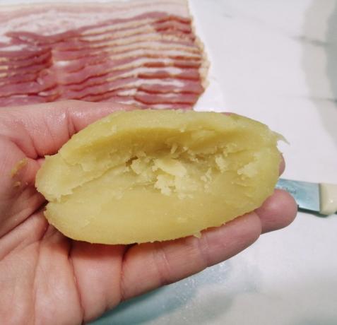 Peel potatoes, cut it in half with a knife carefully cut out the middle