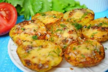 Potatoes baked in the oven with cheese and garlic. Fragrant and tasty