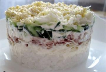 Salad with canned fish and cucumber on the New Year 2019