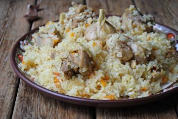 Pilaf with chicken in a saucepan on the stove